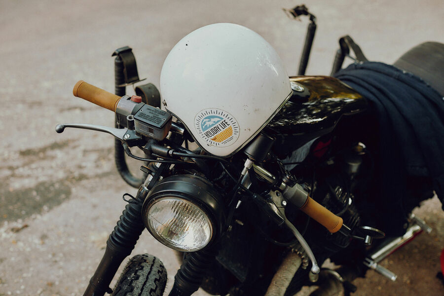 Close-up of an oldtimer motorcycle with a white helmet on it