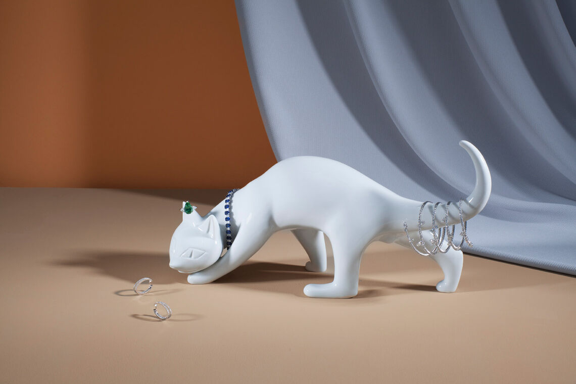KPM porcelain figure "Sneaking tomcat", designed by Johannes Henke and decorated with ring, bracelet and spiral bangle