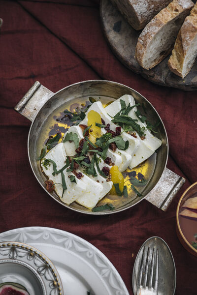 Marinated goat cheese arranged in a pot