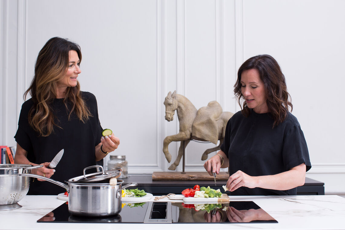 Rachel Richmond and her business partner Xante Weir cook together in kitchen with BORA extractor system