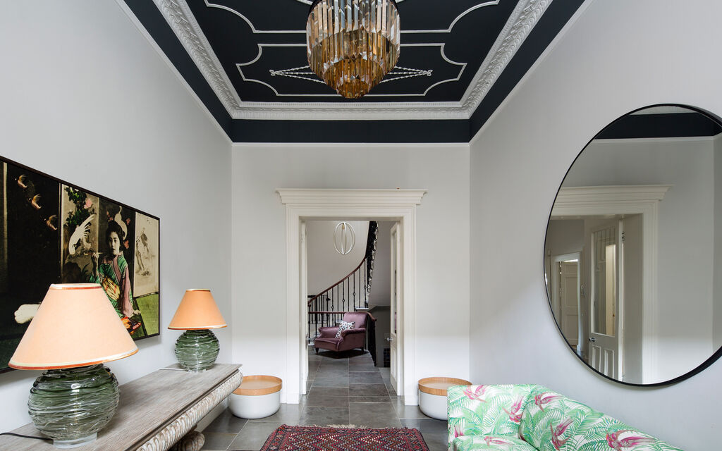 View of entrance area with mirror, chandelier and several floor lamps