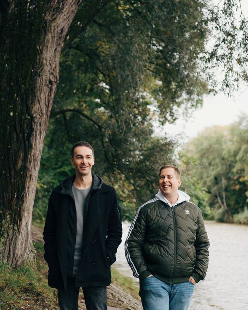 IsarSlam organizers Pierre Jarawan and Ko Bylanzky stand on the banks of the Isar in Munich