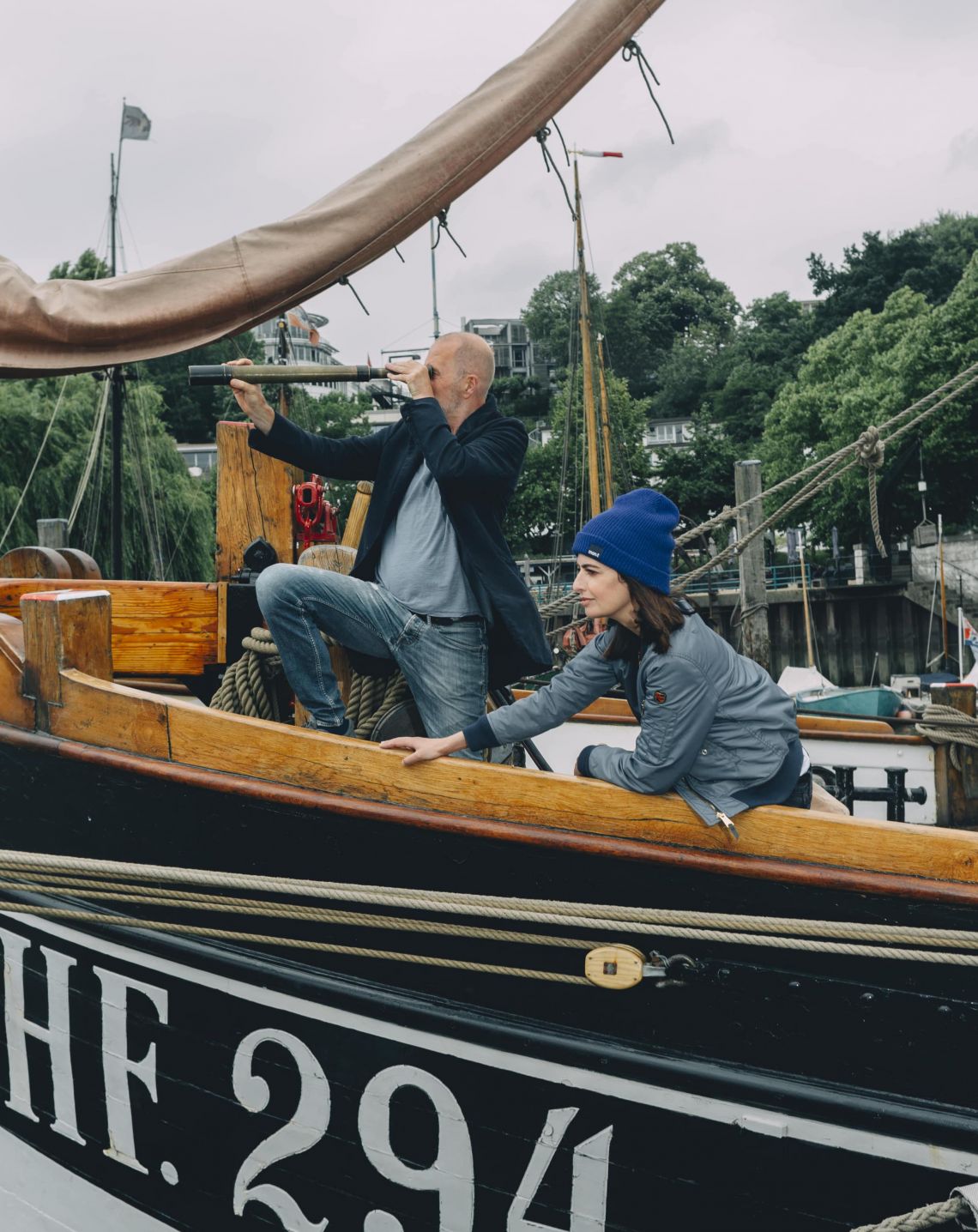 Linda Zervakis and Peter Lohmeyer standing on a sailboat