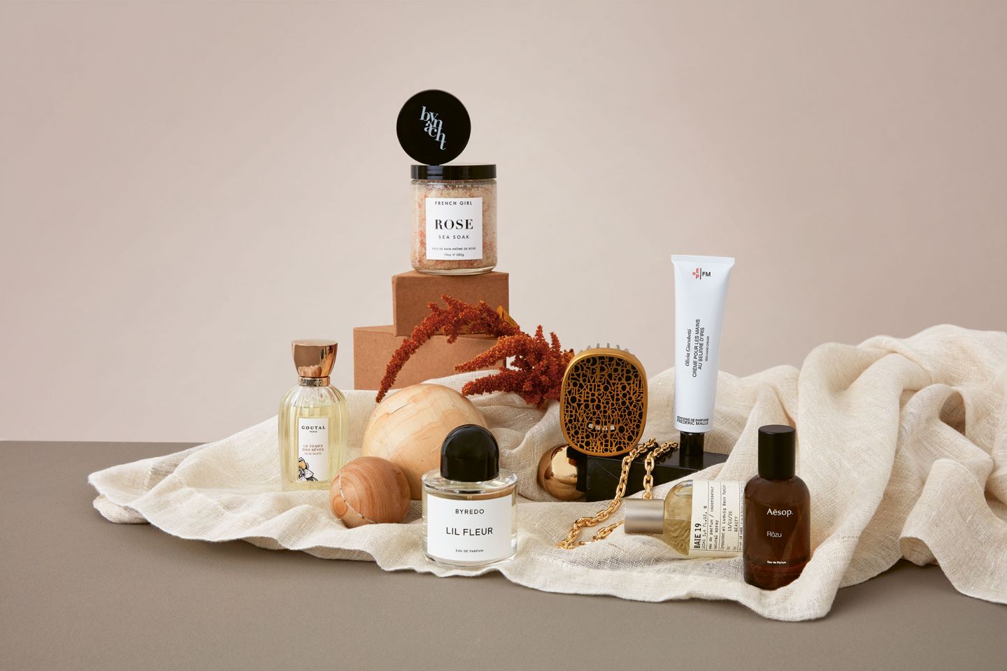 Still life on a beige blanket on which beauty products are arranged