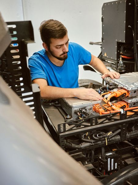 Mechanic working on electric motor of truck