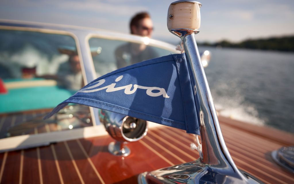 Small boat flag with Riva lettering waving in the breeze