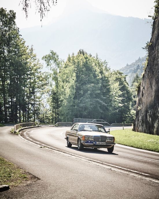 Grauer Oldtimer fährt auf Landstraße