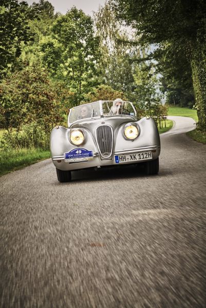 Grey classic car on country road