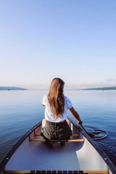 Young woman in canoe rowing