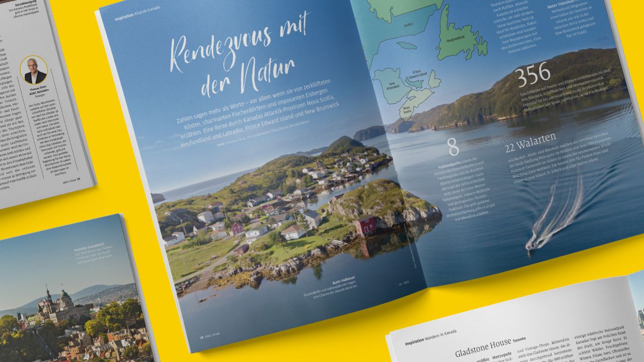 A double-page spread in the travel magazine ADAC Urlaub shows a coastal village in a bay under the headline “Rendezvous with nature.”