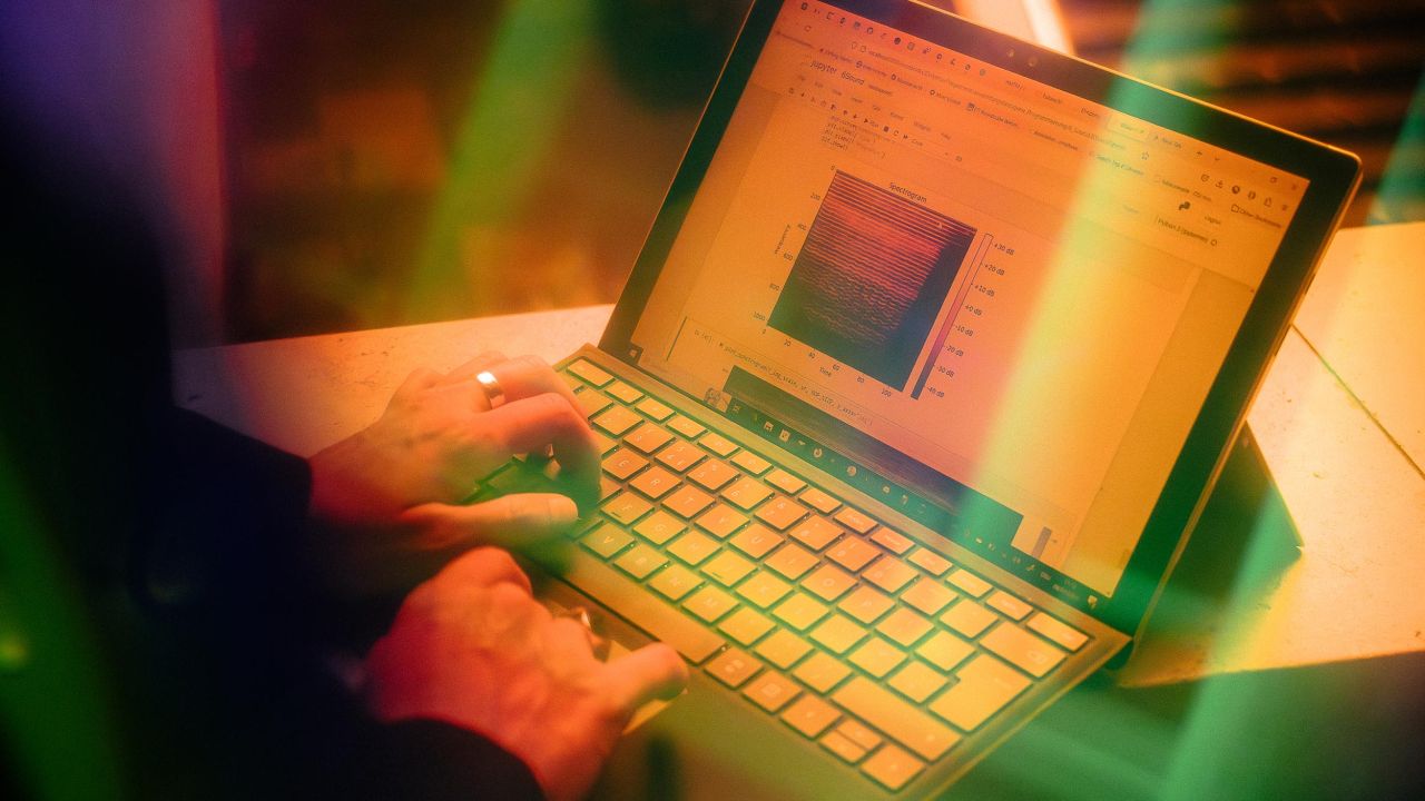 Close-up of hands typing on a laptop